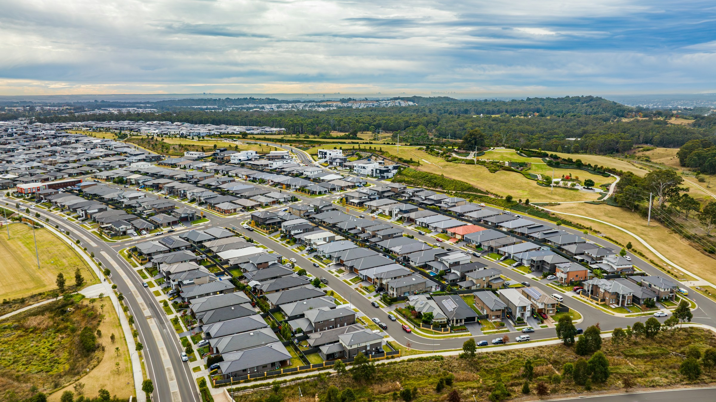 An aerial view of a new housing estate on the edge of an Australian growth corridor